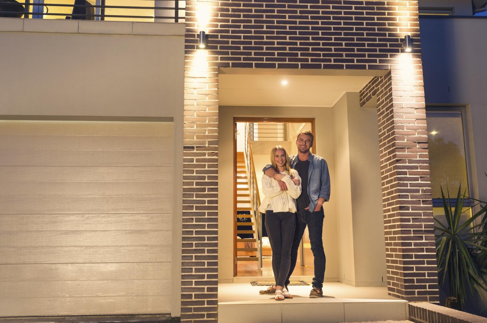 Exterior lights curb appeal young couple at night