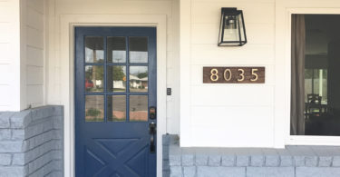 blue door gray brick white siding home exterior 8035