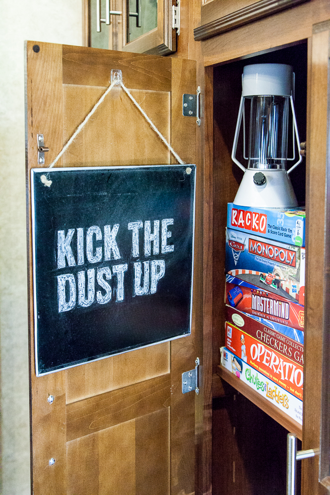 kick the dust up rv decor board games stored in closet