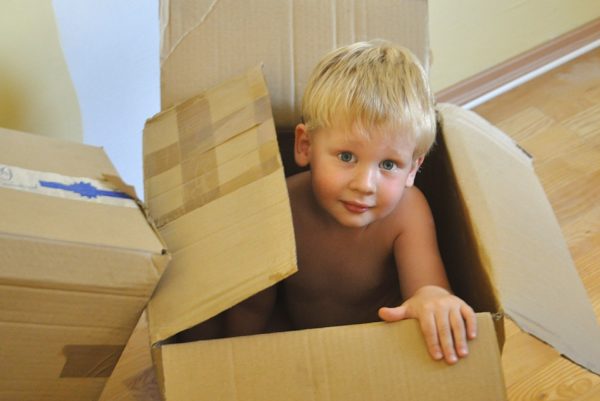 Moving with children tips - blond boy moving box