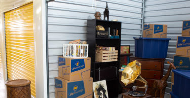 10x15 storage unit with trophies, boxes and other belongings