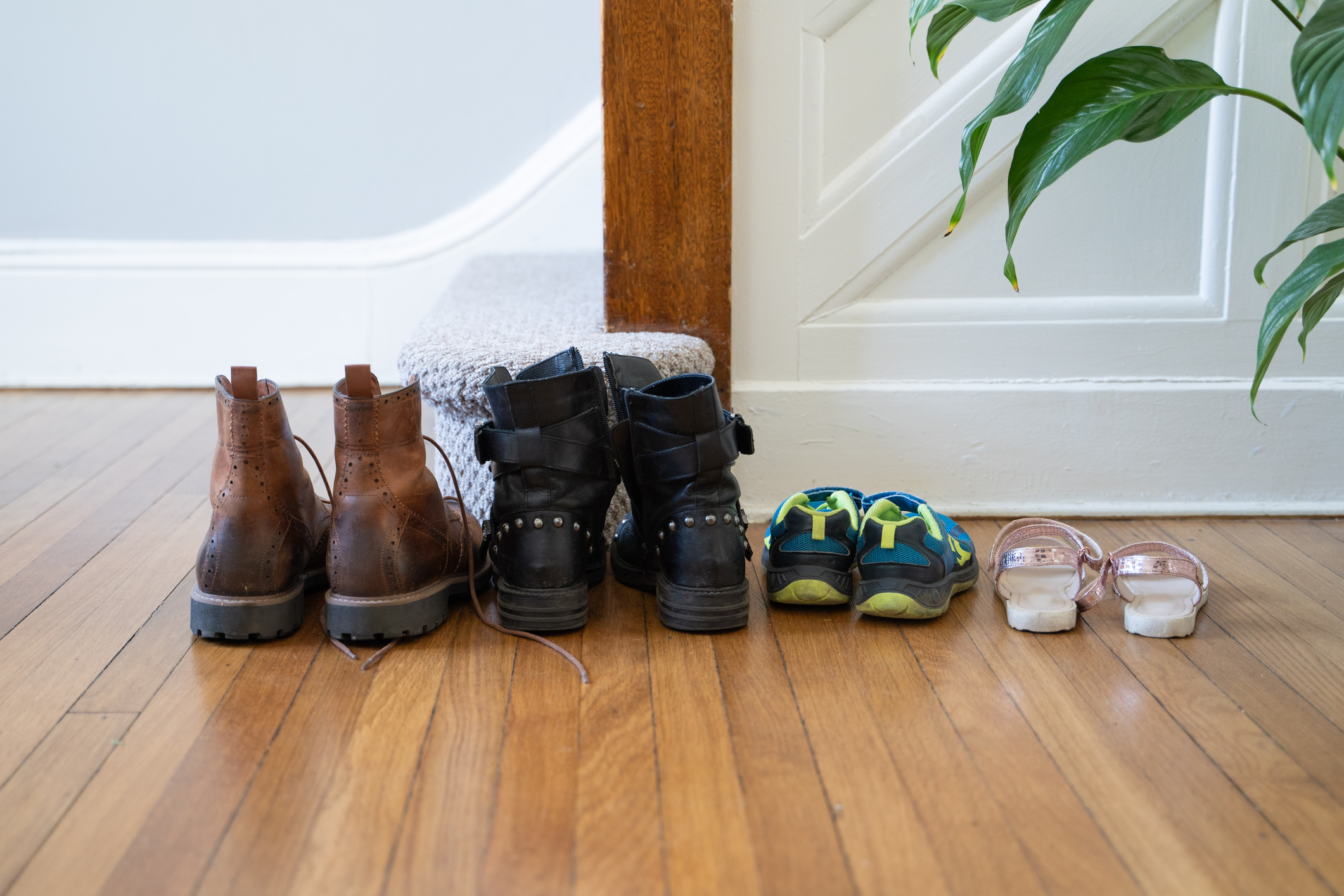 Image of a family's coats and shoes lined-up