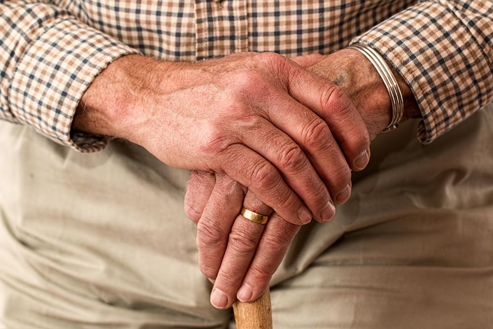 Senior hands with cane