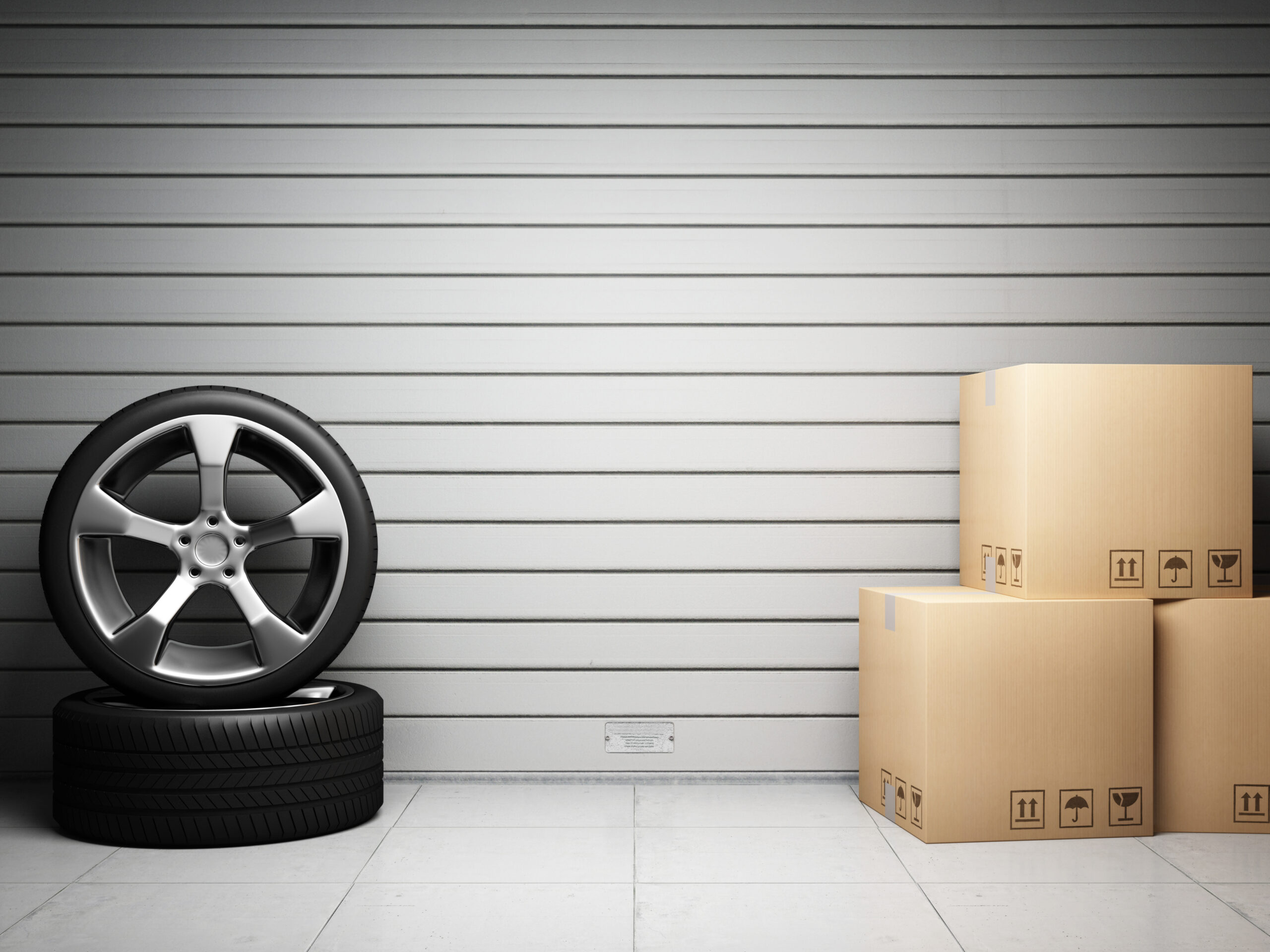 Car tires and storage boxes in front of roller shutter door