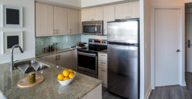 how to organize a small kitchen Kitchen interior of small rental condo property in uptown Toronto. Features large windows and open concept living/kitchen space