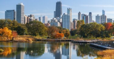 Photo of Chicago skyline during the daytime with trees and waterfront view. Featured image for Pros and Cons of Living in Chicago